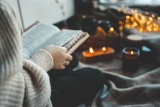 A-girl-with-a-Bible-sitting-by-candles.jpg