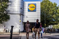 london-united-kingdom-people-walk-past-a-lidl-store-in-london-lidl-is-a-chain-of-german.jpg