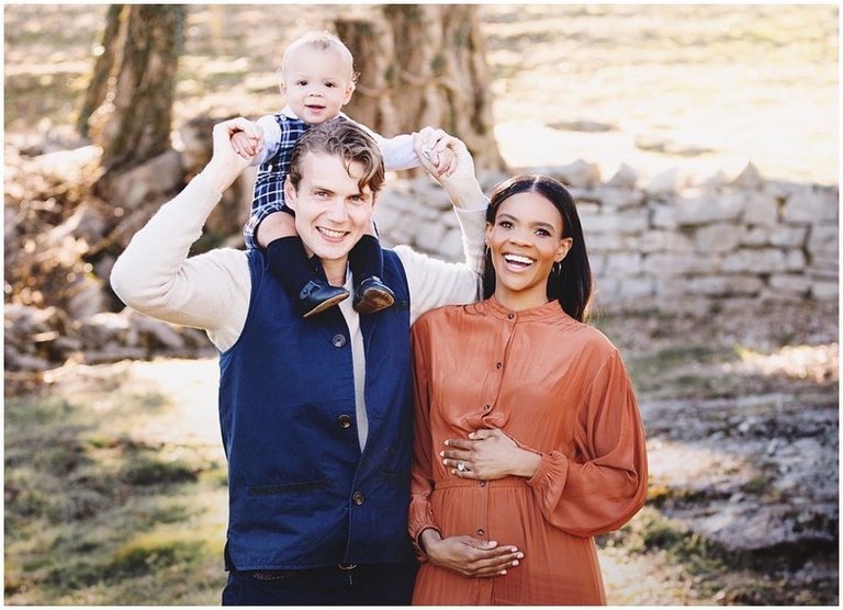 George Farmer carrying son on shoulders with pregnant Candace Owens outdoors