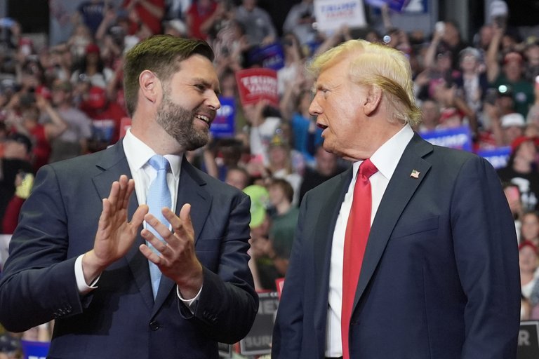 JD Vance (left) and Donald Trump on stage at a campaign event