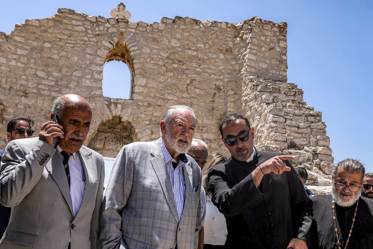 Church leaders at damaged historic stone building